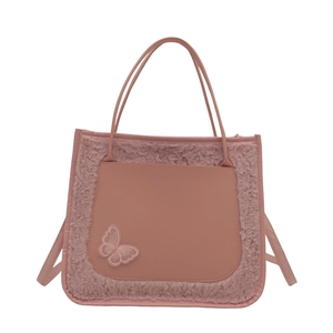 Pink plush tote bag with PU leather pocket and butterfly embroidery on white background