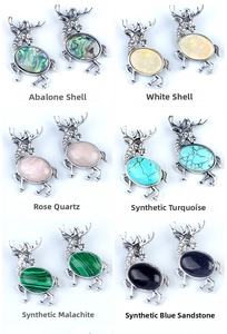 Detail view of six alloy elk brooches with diverse gemstone inlays in retro silver
