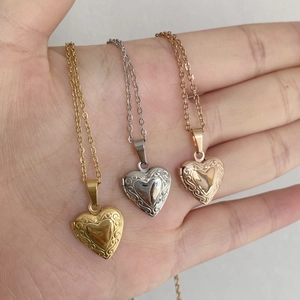 Detailed view of heart-shaped locket necklaces in gold, silver, and rose gold finishes