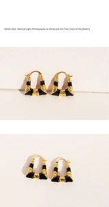 Detail shot of black enamel trapezoid earrings with vintage golden texture in natural light