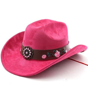 Detail of embroidered floral leather band and metal disc on hot pink western cowboy hat