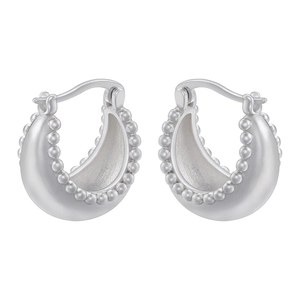 Detailed view of silver hoop earrings with delicate beaded edge texture on a white background
