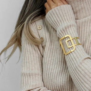 Polished 18K gold plated stainless steel open cuff bracelet with geometric cutout