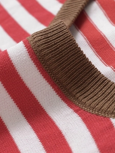 Close-up of red and white striped knit fabric with brown ribbed neckline detail