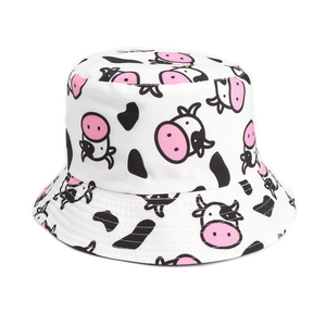 Detail of white cotton bucket hat with black and white cow print and pink nose accents