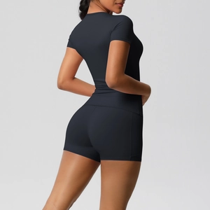 Detail view of moisture-wicking charcoal yoga set featuring high-waist shorts and slim top