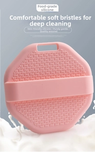 Macro detail of food-grade silicone bath brush with soft pink bristles and hand strap