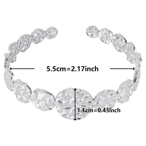 Detailed view showing a 5.5cm diameter for the C-shaped hammered steel bangle
