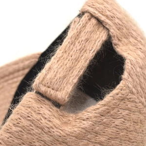 Close-up of khaki knitted beanie showing soft wool texture and black inner lining