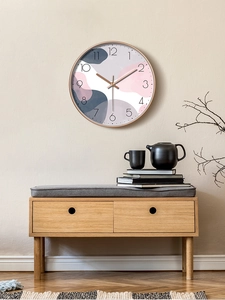 Detail of creative 12 inch silent wall clock featuring abstract pink and purple dial blocks