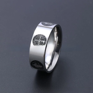 Macro view of polished stainless steel Saint Benedict Medal religious ring with engraving
