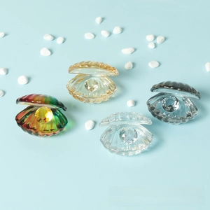 Detail view of crystal shell ornaments in four colors with embedded faceted gemstones