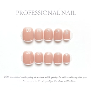 Detail of pink press-on nails with white French tips and minimalist line art decor