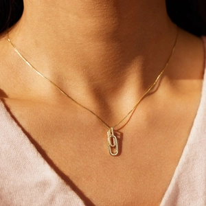 Detail of interlocking S925 silver double ring necklace with zircon inlay on model