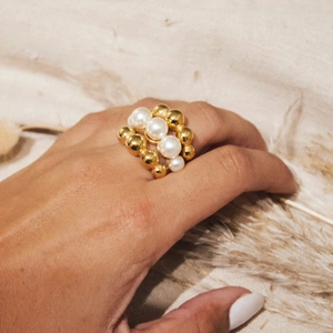 Minimalist pearl and gold beaded titanium steel ring for women shown on model