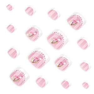 Pink French press-on toenails with white floral tulip designs and lace patterns