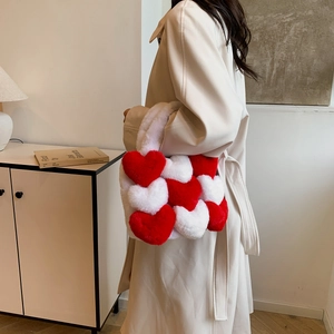 Close-up of red and white plush heart tote bag texture and soft faux fur handle