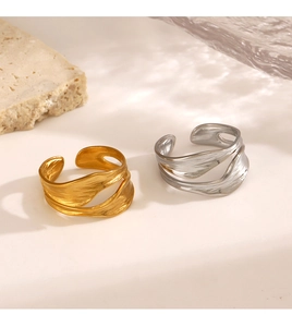 Macro view of adjustable wavy 18K gold plated ring with organic hammered texture