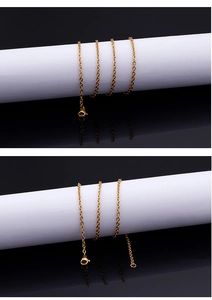Detail of a golden stainless steel O-chain necklace with a lobster clasp on a black mirror