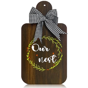 Rustic farmhouse wooden cutting board decor with Our nest wreath and gingham bow