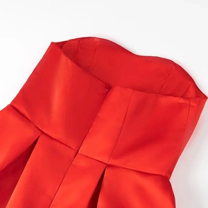 Detail view of the red satin strapless dress with invisible back zipper and waist pleats