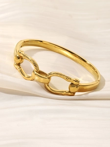 Macro view of 18K gold plated cuff bracelet with textured triple link chain detail