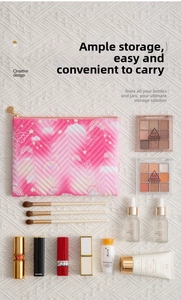 Detail of pink quilted cosmetic bag with butterfly prints and gold zipper closure