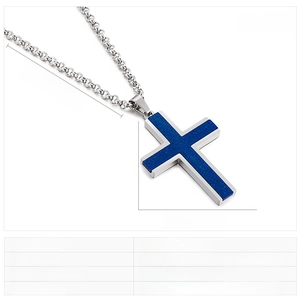 Macro shot of stainless steel cross pendant with textured blue inlay on a silver chain