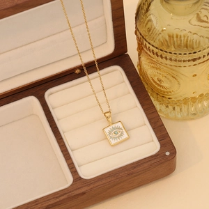 Gold evil eye necklace with turquoise square pendant in velvet lined jewelry box