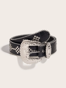 Detail of black faux crocodile leather belt with silver studs and engraved western buckle