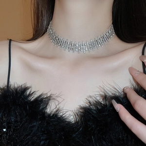 Close-up of sparkling silver geometric choker necklace featuring multi-row diamond strips