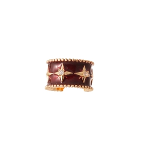 Elegant zircon bow ear cuff in gold finish with star pattern and red enamel details