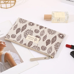 Canvas cosmetic bag with botanical leaf print, portable zipper pouch for women and daily use.