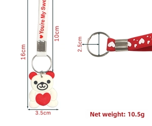 Detailed view of red and white silicone bear keychain with heart and size measurements