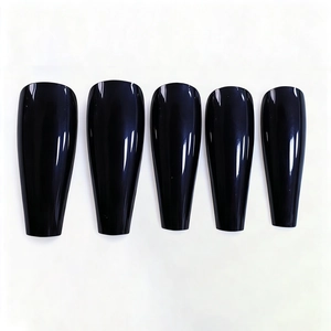 Detailed view of glossy black coffin press-on nails with long trapezoid shape finish