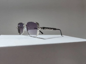 Detail view of silver metal frames and purple gradient lenses on steampunk sunglasses