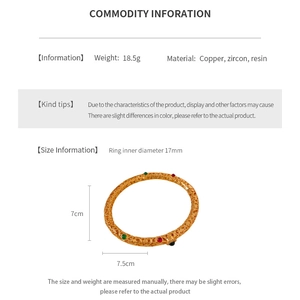 Detail view of 24K gold plated etched bangle with zircon inlays and 17mm inner diameter