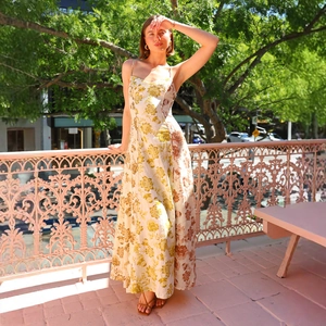 Detail of the backless floral maxi dress featuring vintage print on light fabric