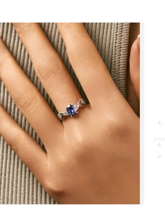 Macro detail of retro S925 silver ring with blue oval gemstone and mermaid tail carvings