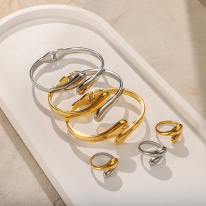 Minimalist teardrop stainless steel jewelry set with polished gold and silver bangles and rings