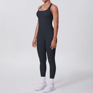 Detail view of black ribbed yoga set featuring racerback tank top and high waist leggings