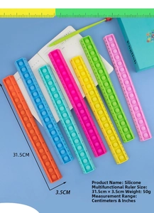Macro detail of 31.5cm colorful silicone pop fidget ruler showing dual measurement scales