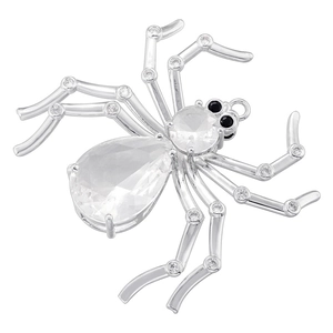 Detailed close-up of a silver spider pendant featuring a pear-shaped clear gemstone