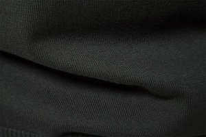 Macro shot of dark olive green knit fabric texture and soft wool blend material