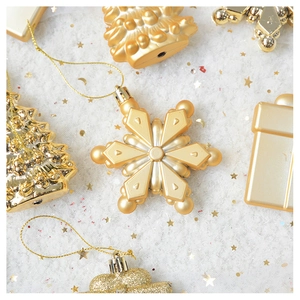 Detailed close-up of gold Christmas tree ornaments with glitter texture on star backdrop