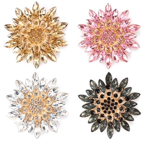Detailed macro view showing four colors of sunflower crystal brooches for coat accessories