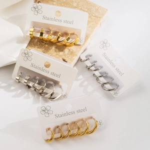 Minimalist stainless steel hoop earrings set in gold and silver on white display cards