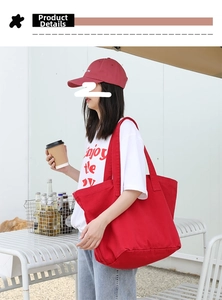 Detailed view of the red canvas tote bag showing thick durable fabric and wide strap