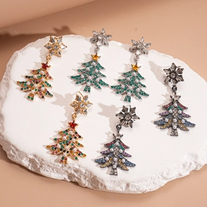 Close-up of snowflake and Christmas tree earrings with rhinestones and pearls