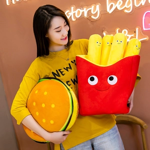 Plush hamburger and red French fries pillow set for kids held by a model in a room